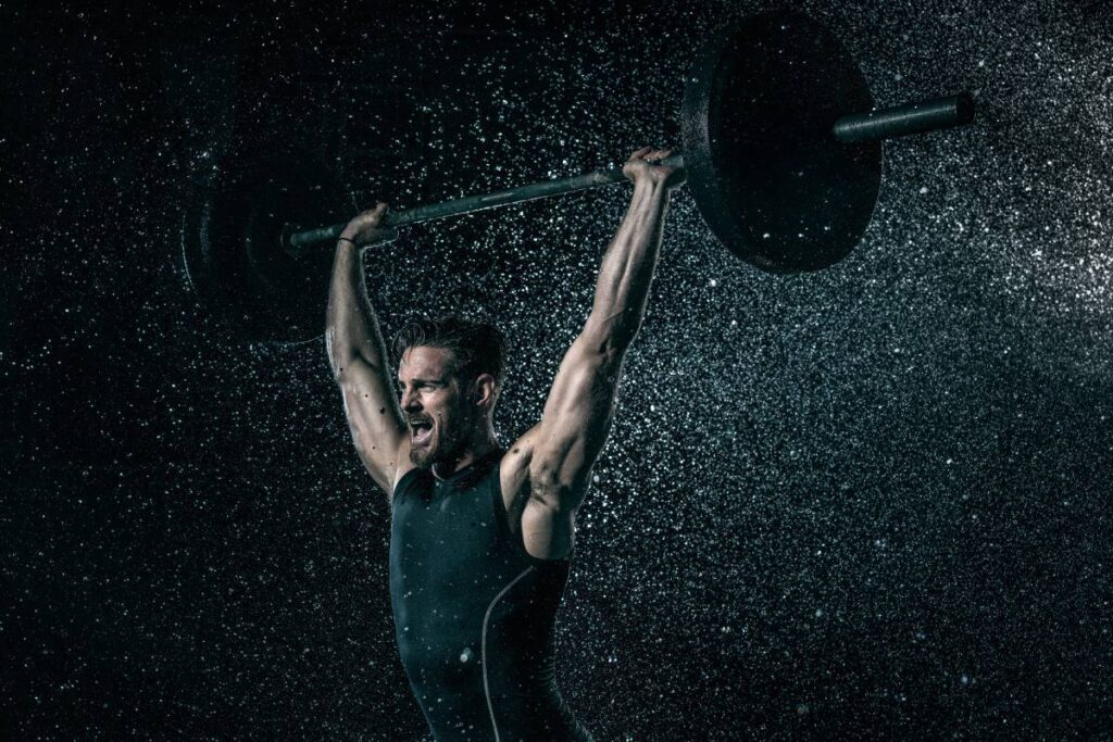 MId adult man, outdoors, lifting weights in rain